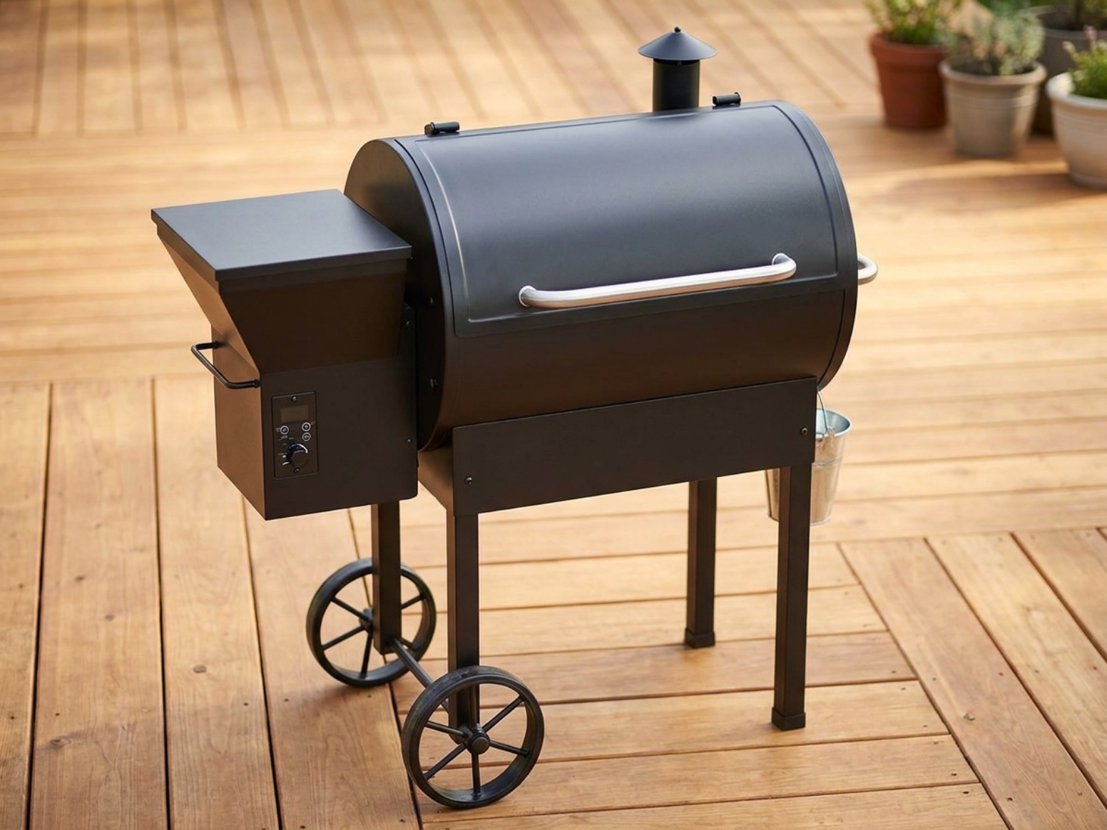 Pit Boss 500FB2 style pellet grill on a wooden deck with its lid closed